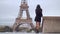 Parisian woman near the Eiffel tower in Paris, France.