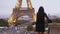 Parisian woman near the Eiffel tower in Paris, France.