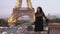 Parisian woman near the Eiffel tower in Paris, France.