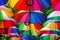 Park alley is decorated with multi-colored umbrellas. Canopy made of rainbow umbrellas