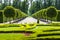 Park alley with symmetrically planted trees.