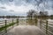 Park area flooded in the UK during winter seen through gate