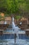 A park art. Cascade of fountains in a desert oasis. The background is blurred