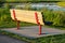 A park bench on a concrete base overlooking a scenic marsh