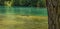 Park bench in flooded mountain lake after thaw