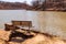 A park bench next to the North Park lake on a sunny spring day