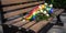 A park bench with a small bouquet of rainbow-colored flowers left behind, symbolizing an lgbt couple recent visit