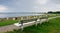 Park bench on top of a dike at the beach of Cuxhaven, Germany