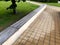 A park bench under trees lined with wood is not wet there is drought