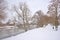 Park covered in snow with bare trees along Emajogi river