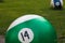 Park figure green billiard ball on grass background