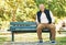 Park, happy and portrait of old man on bench outdoor for fresh air, wellness and relaxing in retirement. Smile, peace