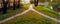 In the park by the highway, two narrow footpaths merged into one. Conceptual evening autumn landscape