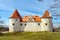 Park with medieval castle with orange roof in Bauska town, Latvia