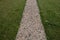 Park path in the outdoor fitness training center. The soft surface of the narrow jogging path is made of wood chips. flexible ecol