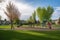 park with playground, basketball court, and picnic area visible in residential neighborhood scene