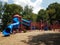 Park with red and pink and blue play structure and slides