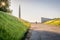 A park with a solitary man and monuments in the distance.