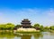 A park in Songjiang, Shanghai, with blue sky and white clouds and green trees.