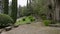 Park with a stone wall, benches and stairs with saturated vegetation near Cathedral of Girona, Spain