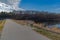 Park trails make for a healthy lifestyle. Here is an empty bench for resting and sight seeing or bird watching in a park