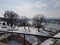 Park trees tourists landmark Belgrade castle fortress in Serbia winter snow sun reflecting river Donau forest sun sky
