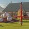 Park with a variety of playground equipment and structures viewed on a sunny day