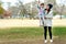 The park is where they have the most fun together. a mother pushing her daughter on a swing at the park.