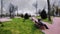 Park woman on a bench in the rain.