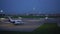 Parked airplanes. Aircraft ready for takeoff. Plane lands in the background. 4K