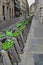 Parked bicycles on the street. City bike rental. A deserted street and bicycles