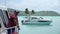 Parked Boat with local sailor in harbor with Turquoise blue lagoon in Bora Bora