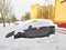 Parked car trapped in huge snow cover. The car was covered with sno