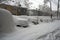 Parked cars blocked by snow