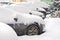 Parked cars covered with snow