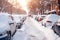 Parked cars covered with snow on street after night snowfall