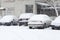 Parked cars covered with snow in the winter