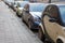 Parked cars in a European city along the cobblestone pavement, Deserted street in the city