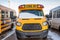 Parked front end of a school bus with the windshield covered with snow after a storm