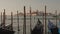 Parked gondolas on Piazza San Marco and The Doge\'s Palace embankment with the bell tower of the Saint Giorgio Maggiore