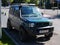 Parked green Suzuki Jimny on the city streets.