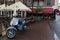 Parked Moped along a Sidewalk with a Beautiful Restaurant in the Background in the Centrum District of Amsterdam