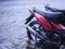 A parked motorbike near the street is partially submerged in flood waters during a sudden storm in the city.