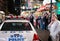 Parked NYPD vehicle seen together with a woman on a phone, seen after an emergency incident.