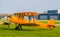 Parked orange stunt airplane at the airport, acrobatic flying and extreme hobbies