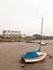 Parked private boat with mast on mud sea front dock