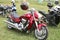 Parked red Suzuki Boulevard M109R motorbike on green grass