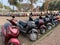 Parked scooters sby a roadside sidewalk at a tourist site in Old Goa