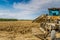 parked tractor in front of plowed field