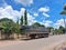 A parked trailer on the side of a road under bright blue sky